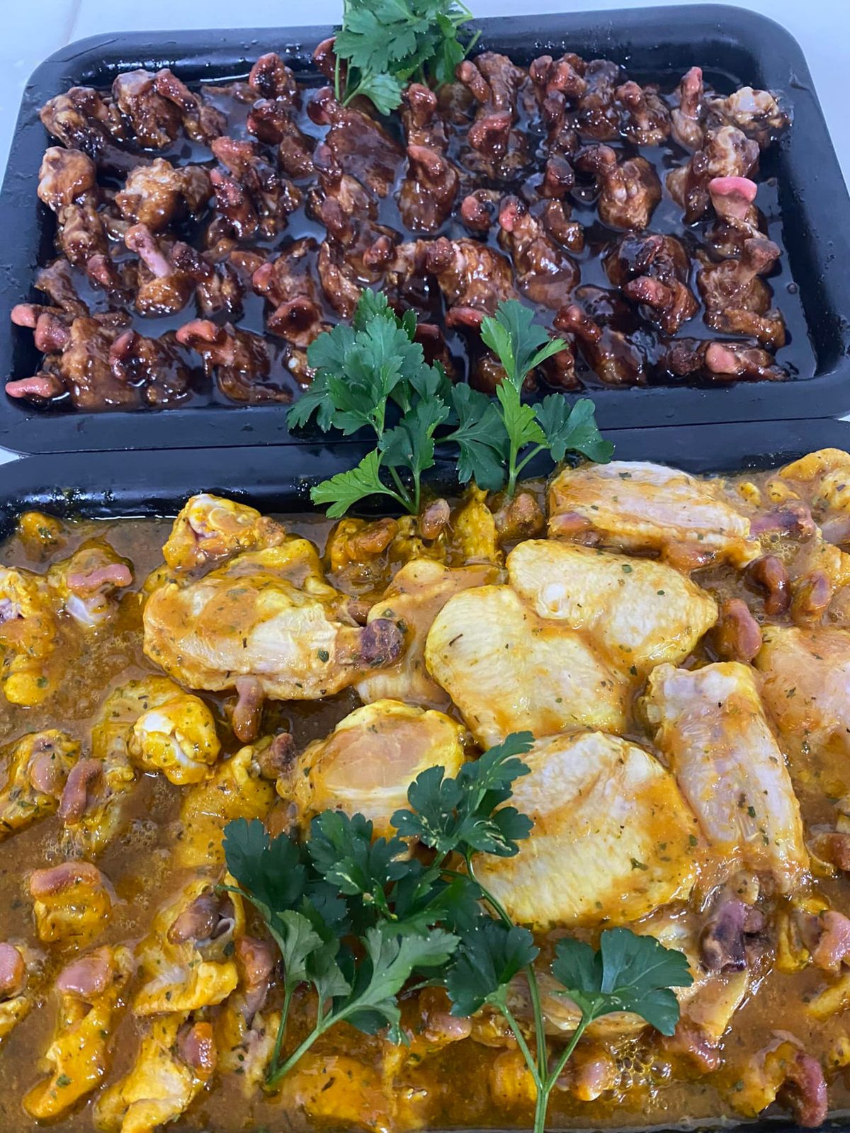 Trays of marinated chicken ready to cook